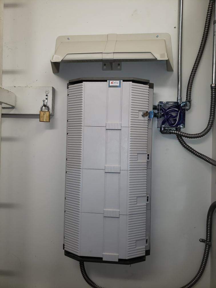Electric Meter Rain Hoods and Shields mounted above an exterior water heater on a mobile home.