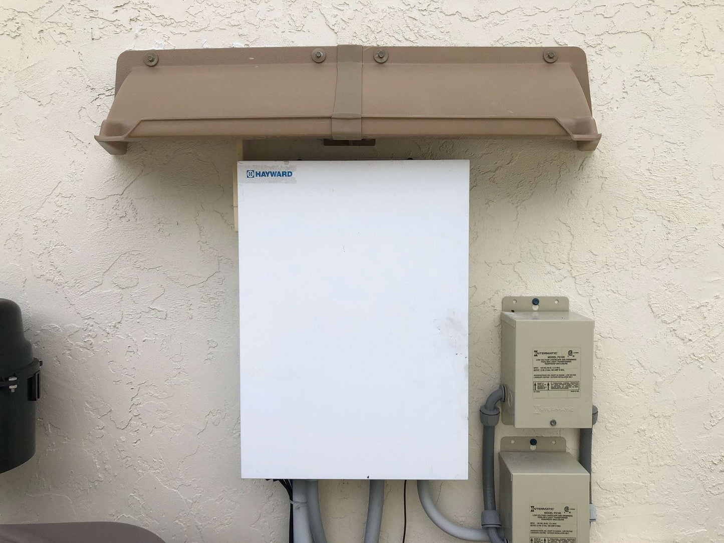 Electric Meter Rain Hoods and Shields mounted above pool electrical equipment.