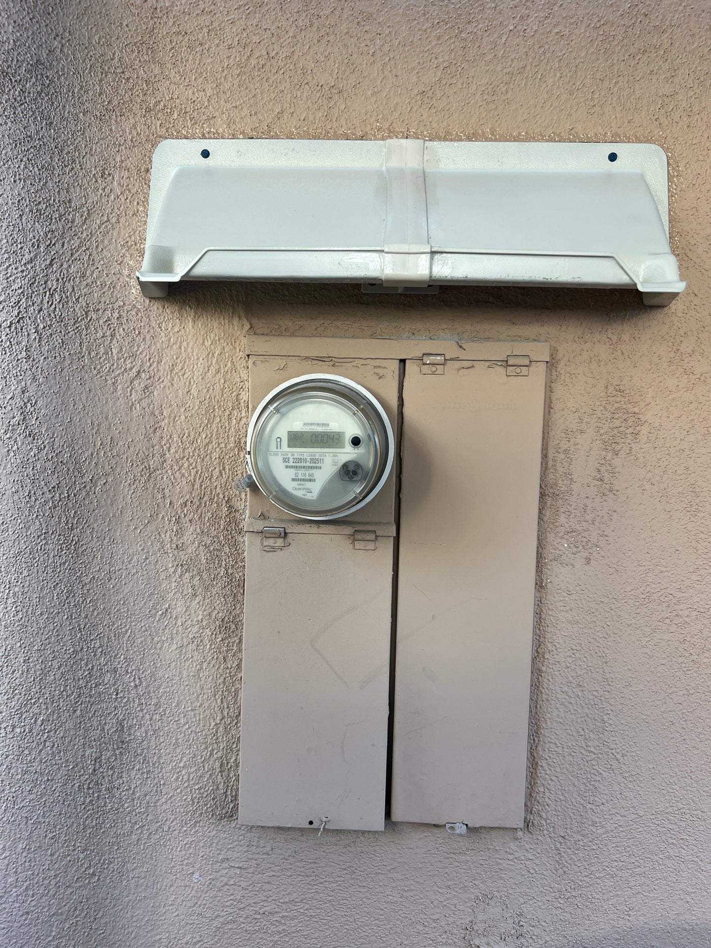 Electric Meter Rain Hoods and Shields mounted above an electric meter box cover.