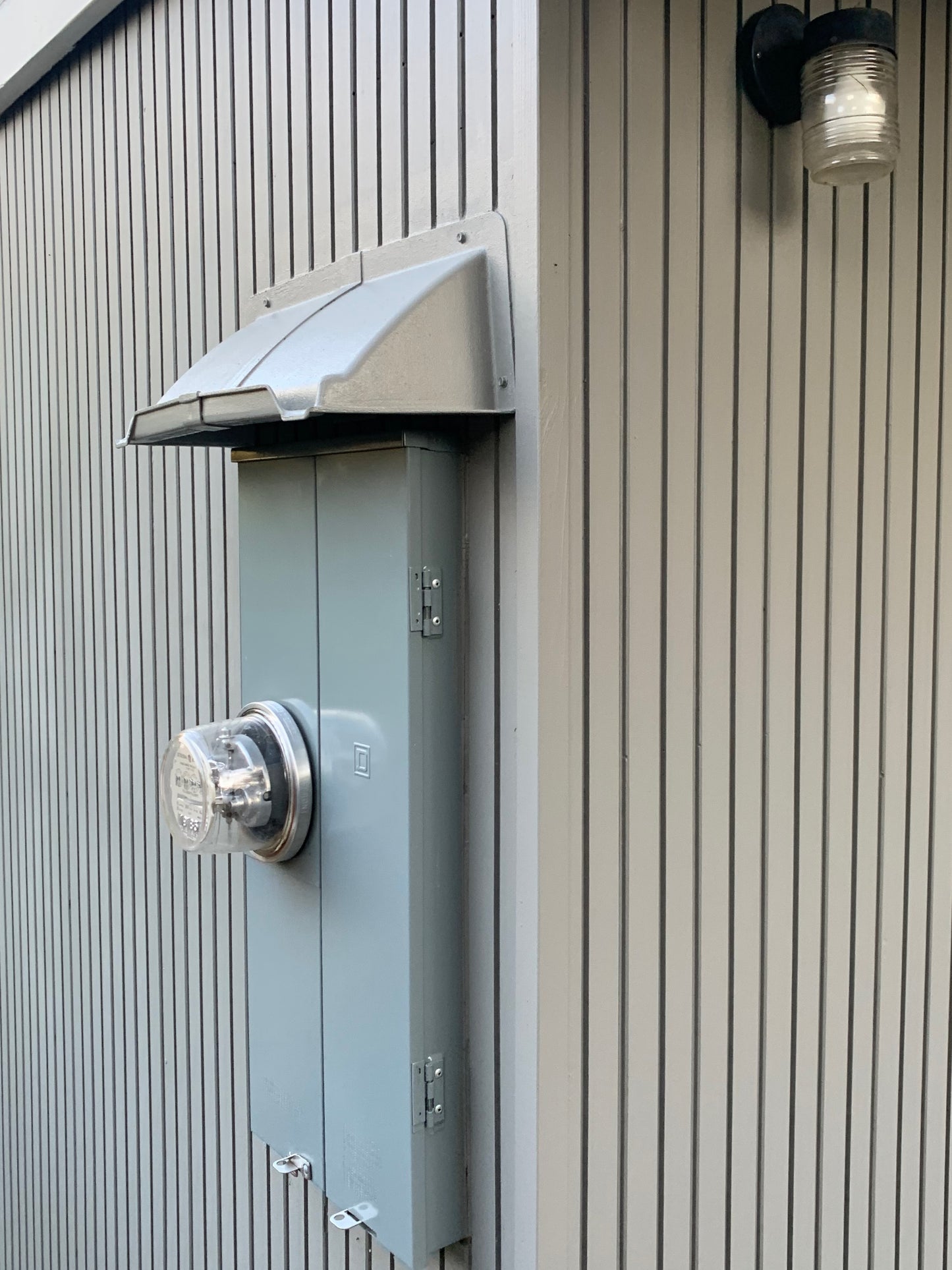 Electric Meter Rain Hoods and Shields mounted above an electric service panel.