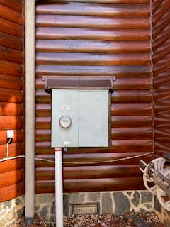 Electric Meter Rain Hoods and Shields mounted above an electric service meter box.