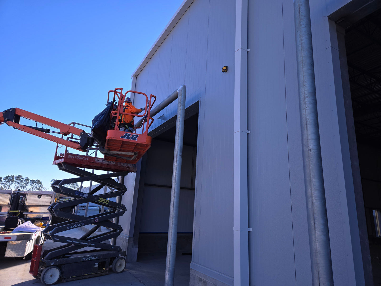 Garage door rain diverter installed with extended width and splice bracket to fix leaking windows by redirecting water away.