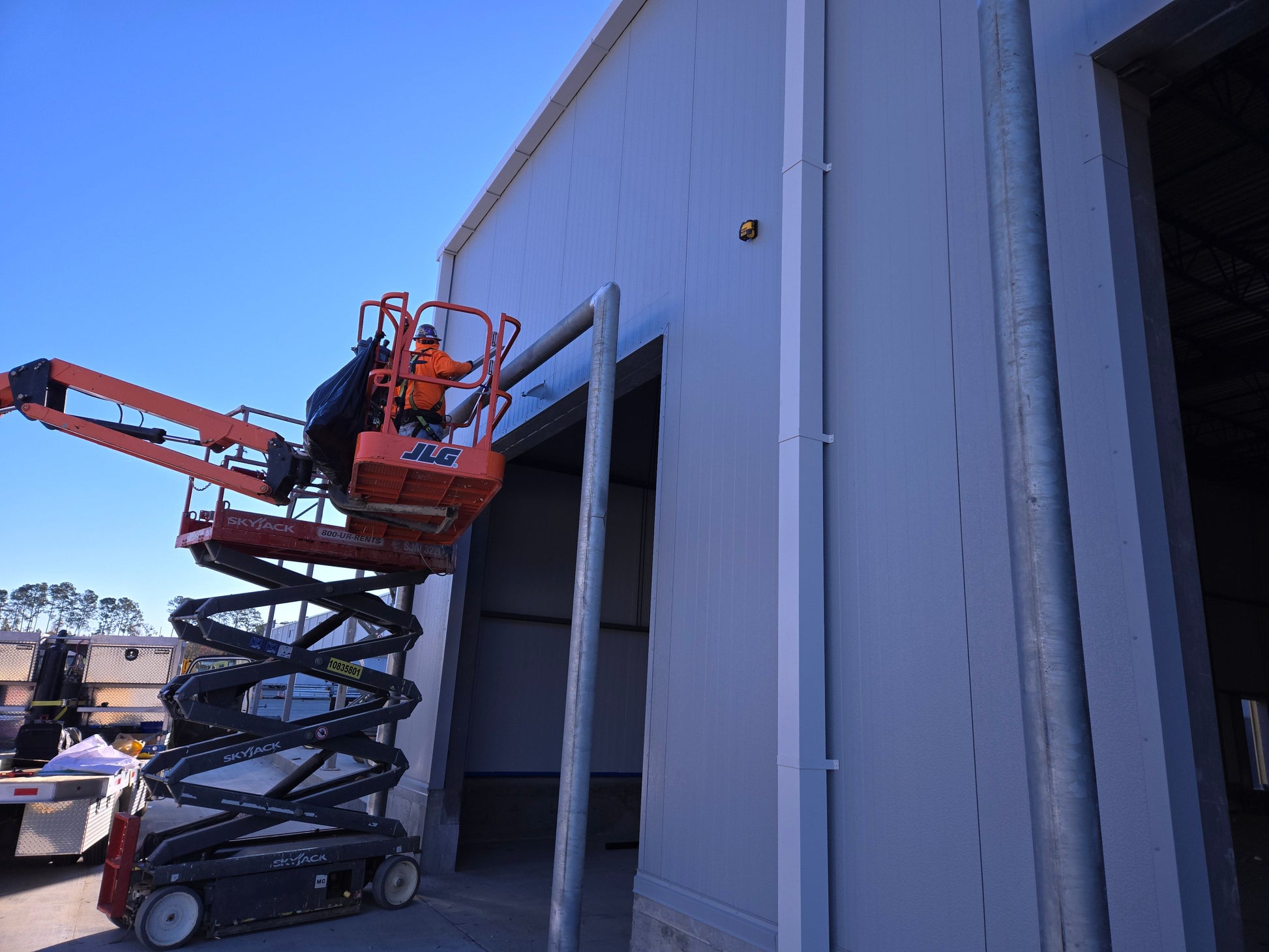 Garage door rain diverter installed with extended width and splice bracket to fix leaking windows by redirecting water away.