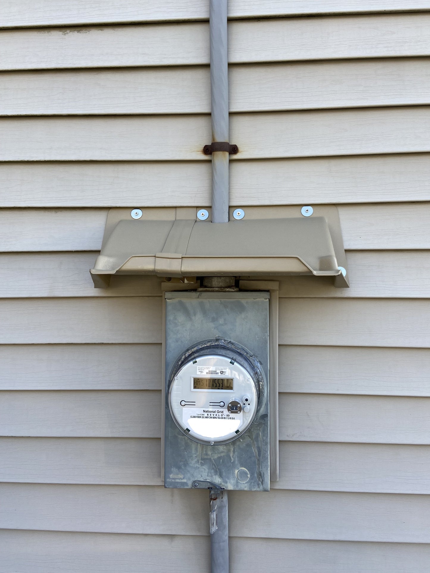 Electric service rain diverter mounted on panel to prevent water damage and rust
