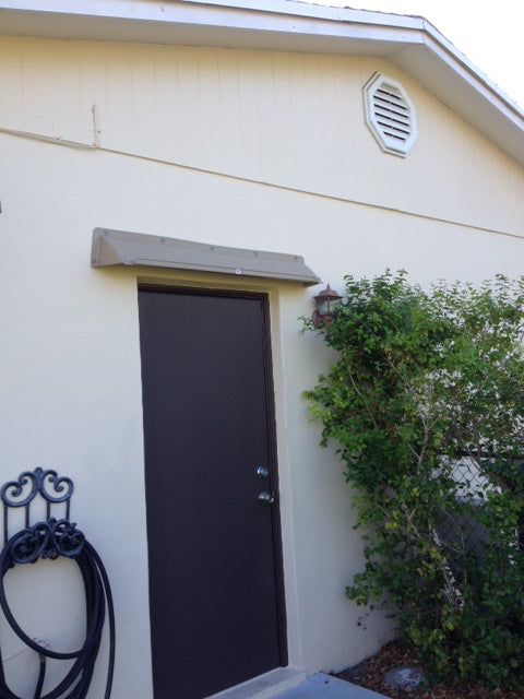 Overhead door rain guard with gutter to stop leaks, 52-inch standard width, durable ABS plastic, available in multiple colors, made in USA