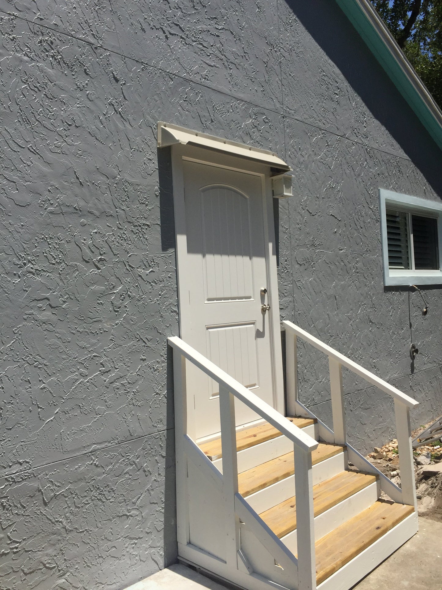 Overhead door rain guard in 52-inch width protecting house door from leaks and drips with durable ABS plastic design