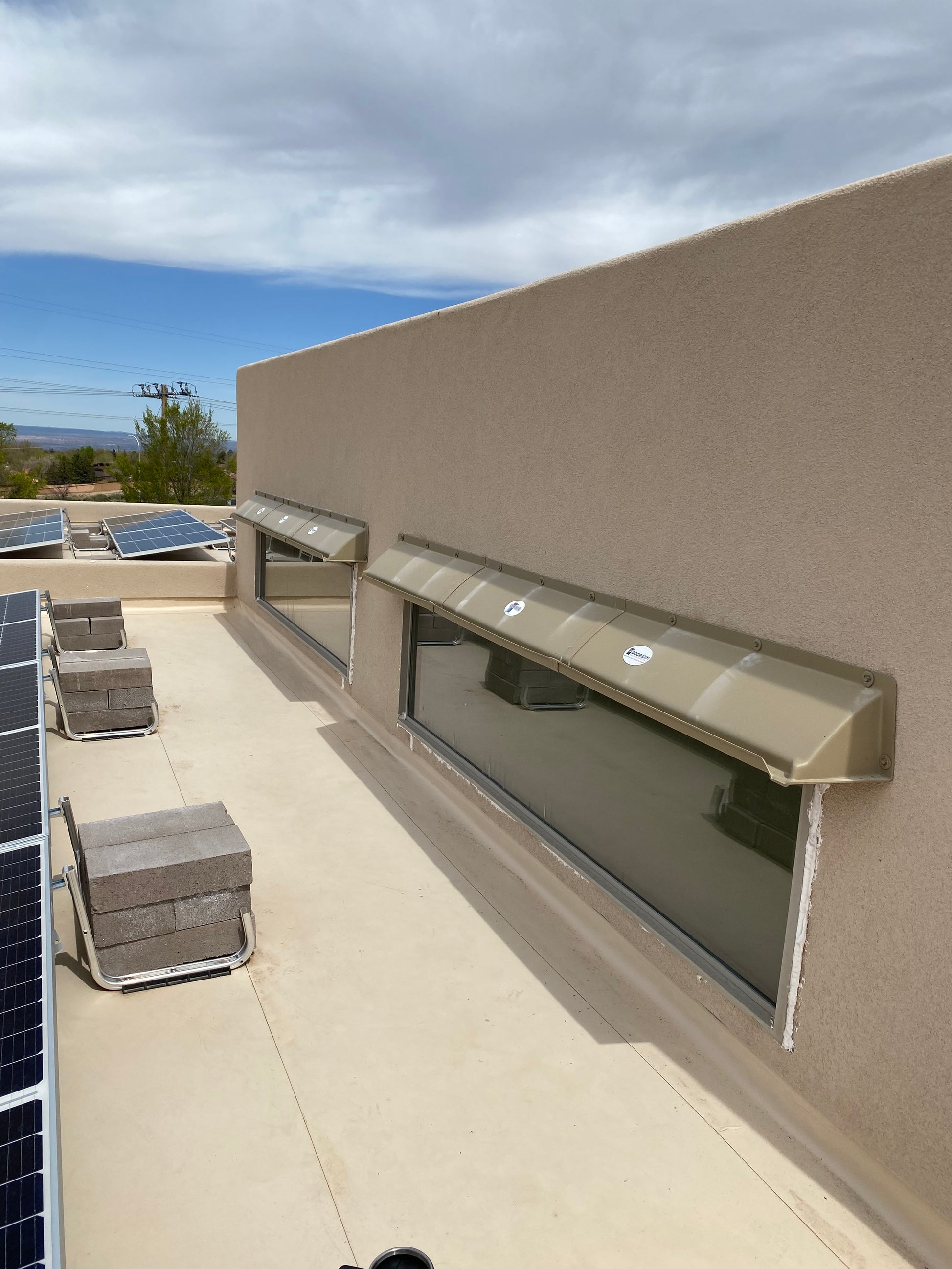 Rain guards for house above clerestory windows.