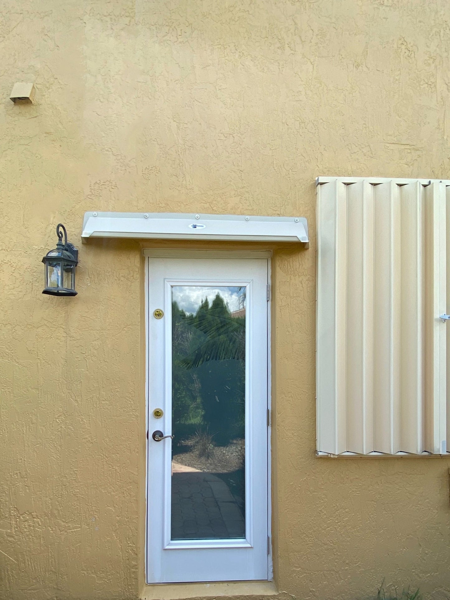 Overhead door rain guard with gutter stops for 36-inch door, durable ABS plastic, almond color, made in USA