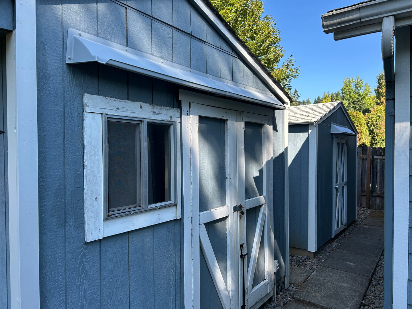 Double door leak rain guard installed on shed doors to prevent water leaks and keep storage dry