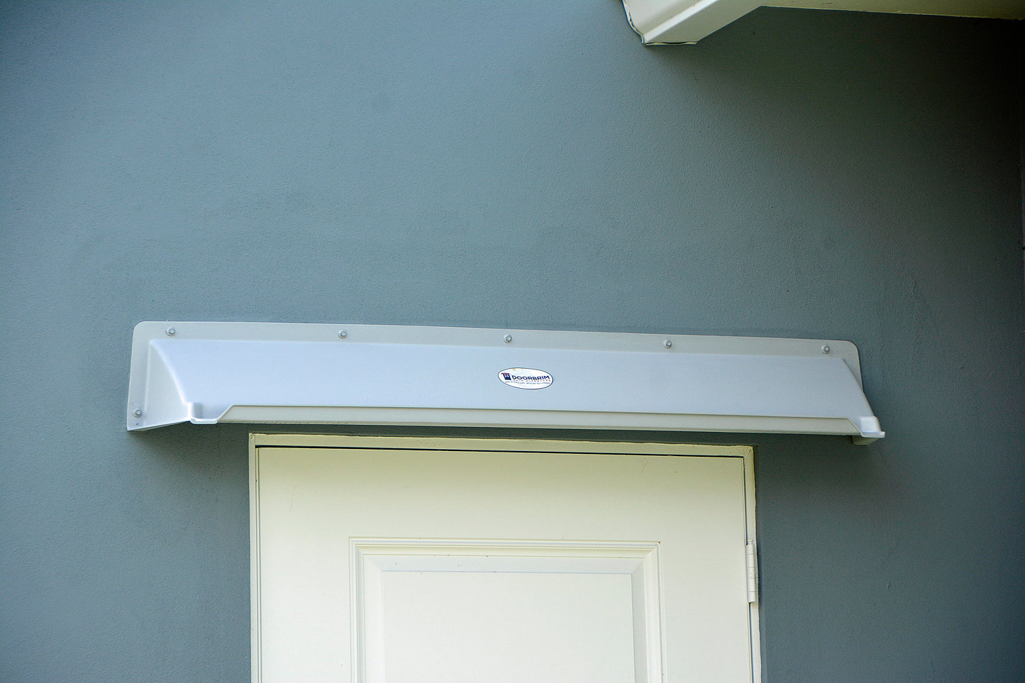 Overhead door rain guard rain diverter over door protecting house from leaks and drips