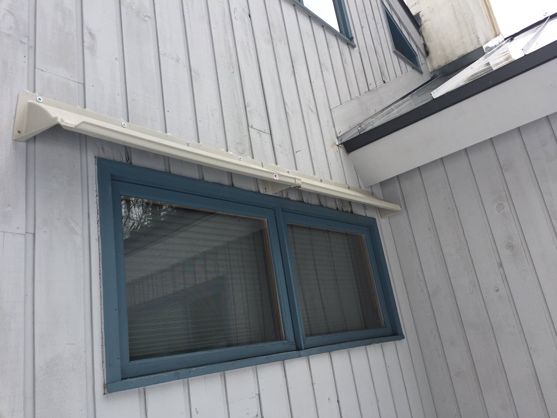 fix leaking windows during heavy rain with a DOORBRIM rain diverter shown above a horizontal sliding window.